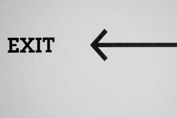 a black and white photo of an exit sign