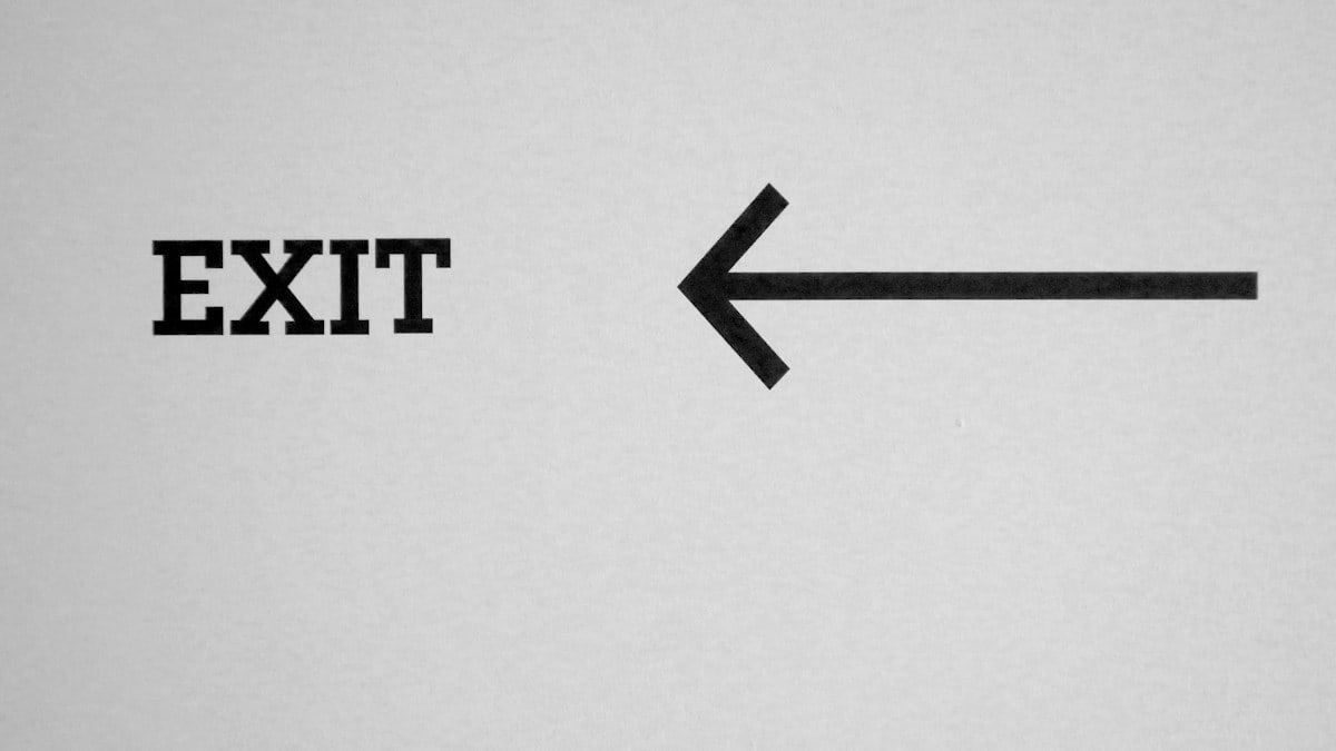 a black and white photo of an exit sign